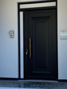 a black door with a handle in a building at Artelie apartment in Kyparissia