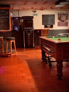 a kitchen with a pool table in a room at Cain Valley Hotel in Llanfyllin