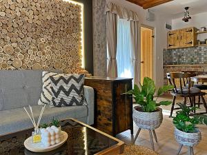 a living room with a couch and a table at Cityside Cottage in Eger