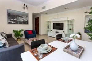 a living room with a couch and a table at HiGuests - Modern Apt in Dubai Marina With Pool and Gym in Dubai