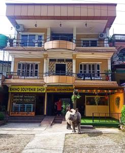 a large bull standing in front of a building at Hotel Rhinoceros-Homestay in Sauraha