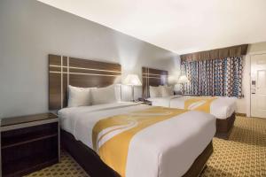 two beds in a hotel room with two at Quality Inn Madisonville in Madisonville +33 photos