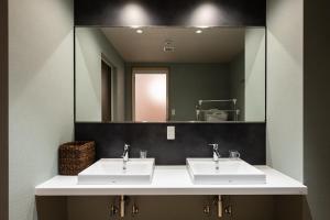 a bathroom with two sinks and a large mirror at Volcano in Kagoshima