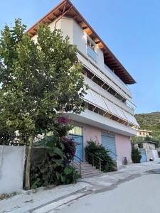 uma casa com uma árvore em frente em ADRIATIK Hotel em Vlorë