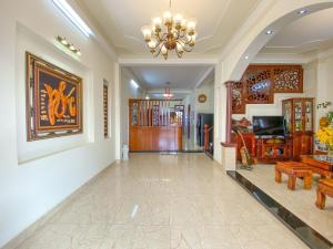 a hallway with a chandelier and a living room at Jolie Maison Đà Lạt in Da Lat