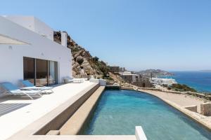 a swimming pool with a view of the ocean at Villa Paschalia,Sea View, Pool, Gym, Sleeps 10 in Mikonos