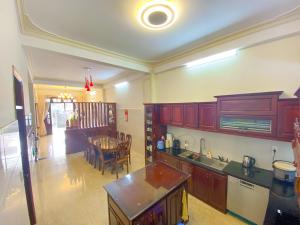 a kitchen with a table and a dining room at Jolie Maison Đà Lạt in Da Lat