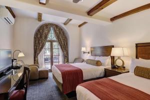a hotel room with two beds and a window at Austria Haus Hotel in Vail