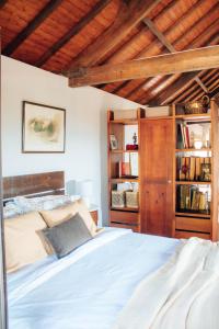 a bedroom with a bed and a book shelf at Just Like Home - Holly House em Cerveira in Reboreda
