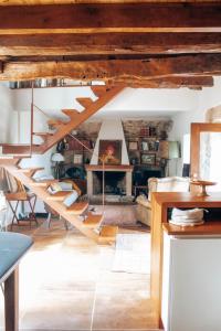 a staircase in a living room with wooden ceilings at Just Like Home - Holly House em Cerveira in Linhares