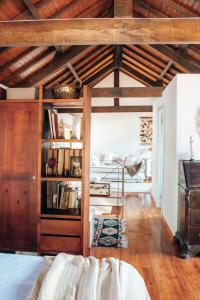 a room with a bed and a book shelf at Just Like Home - Holly House em Cerveira in Reboreda