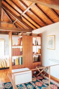 a room with a bed and a book shelf at Just Like Home - Holly House em Cerveira in Reboreda