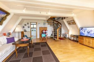 a living room with a couch and a tv at Ferienhaus Düperthal in Hilchenbach