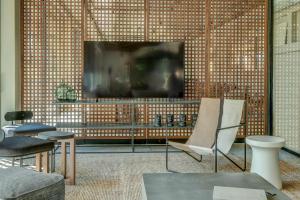 a living room with a television and a chair at Umani Hotel - Free Beach - Free Parking in Golden Sands