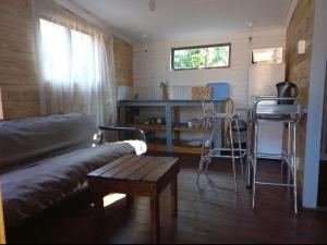 a living room with a couch and a table and chairs at Amaroks self catering units in Sabie