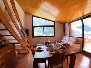 a living room with a table and a couch at Soldeu Paradis Gran Sol in El Tarter