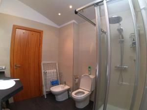 a bathroom with a toilet and a sink and a shower at Soldeu Paradis Gran Sol in El Tarter +70 photos