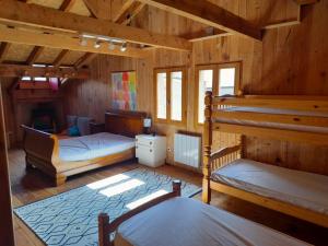 a bedroom with two bunk beds and a fireplace at Maison de montagne dans charmant village du Capcir in Fontrabiouse