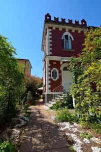 a red and white house with a pathway leading to it at Villa Angelica in Venice-Lido