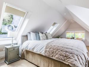 a bedroom with a bed with a large window at Pass the Keys Peaceful And Beautiful Barn In Downland Village in Chichester