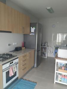 a kitchen with a stove and a refrigerator at Brava in Vila Franca do Campo