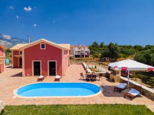 a villa with a swimming pool and a patio at Panorama View Villas - Villa Ostria and Levante in Fokáta