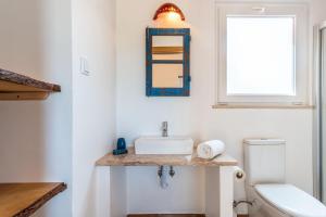 a bathroom with a sink and a toilet at Monte dos Cachoupos in São Luis +24 photos