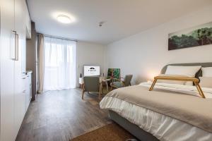 a bedroom with a bed and a table with chairs at Modern Studio good located Balcony King Bed in Frankfurt/Main