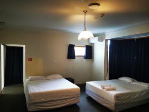 Postel nebo postele na pokoji v ubytování Harrison Motel Papatoetoe
