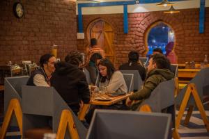 a group of people sitting at a table in a restaurant at Black Sheep Bed & Breakfast in Kargil