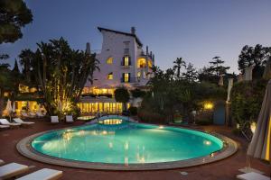 a swimming pool in front of a building at Grand Hotel Il Moresco in Ischia Town