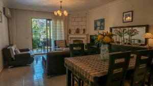 a dining room with a table and a living room at dolphine apatment turunç in Marmaris