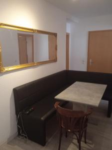 a room with a couch and a table and a mirror at 3 Zimmer Wohnung in Kaiserslautern