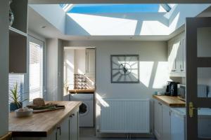 a kitchen with a ceiling with a skylight at Needles Point in Milford on Sea
