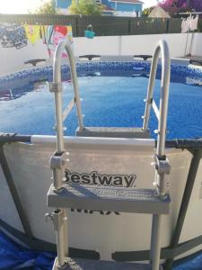 a swimming pool with a gate in front of it at Casa da Praia Alfarim in Sesimbra