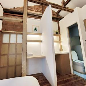 a room with white walls and wooden beams at Jerry's Mazehut Hostel in Tainan +41 photos