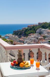 a plate of fruit on a table on a balcony at Castello Apartments in Ulcinj