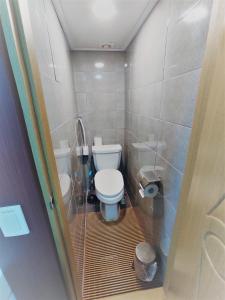a small bathroom with a toilet and a shower at Y's house in Seoul