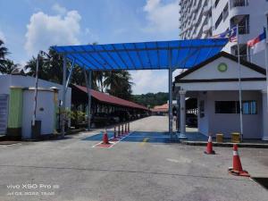 a gas station with a blue canopy in a street at NurIzz Condostay Homestay Pantai Puteri Melaka in Kampong Bukit Darat