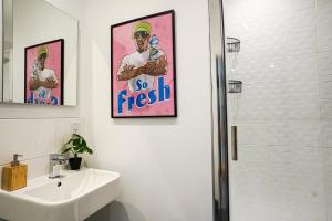 a white bathroom with a sink and a shower at Luxury Stevenage Town Centre Apartment in Stevenage