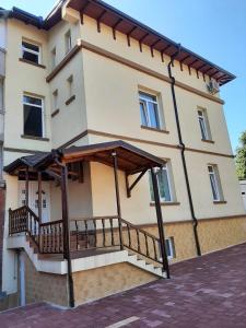 a building with a balcony on the side of it at The Cohen's Guest House in Kyustendil