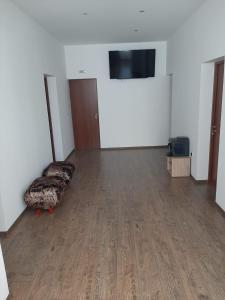 an empty room with a couch and a flat screen tv at The Cohen's Guest House in Kyustendil