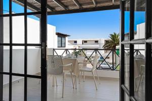 a patio with a table and chairs on a balcony at Casa Marina 14 in Puerto del Carmen