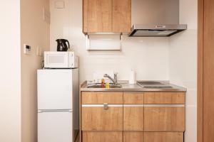 鹿兒島的住宿－T・Kスクエア鹿児島中央，小厨房配有冰箱和微波炉。