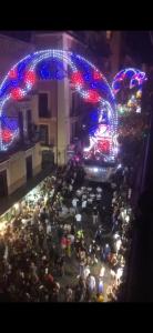 a large crowd of people standing in a street at night at Casa Vacanze Antico Cassaro in Palermo
