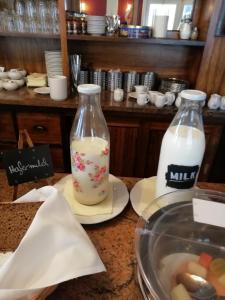 two bottles of milk sitting on a counter at Hotel Zur Linde in Meldorf