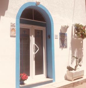 a door is open to a small room with a blue door at La Dimora del Viaggiatore Luxury Apartments in Mazara del Vallo