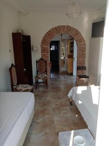a bedroom with a bed and a room with a brick wall at Villa Anna in Tríkeri