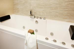 a bathroom with a bath tub with a towel on it at Torre Buen Aire cerca de Valencia, con jacuzzi y barbacoa in Benafer +3 photos