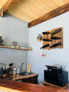 a kitchen with a sink and a knife rack on the wall at Mitarbi Silence - cozy holiday cottages in mountains in Borjomi